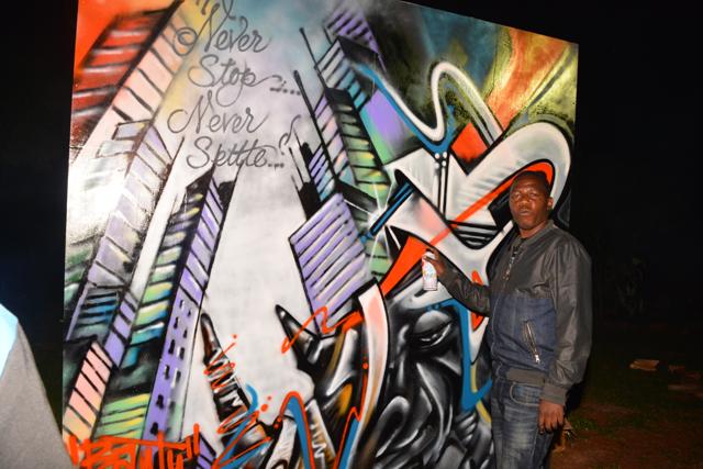 Graffiti artist Bantu next to his piece.